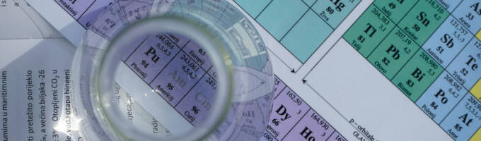 Periodic table with a beaker sitting on top