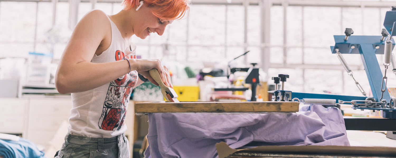 person working on screen print project