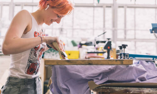 person working on screen print project
