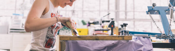 person working on screen print project