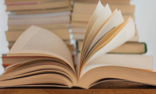 A book open on a table with the pages ruffled