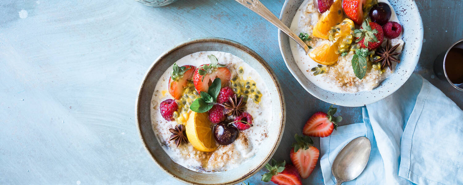 Two bowls of yoghurt and fruit