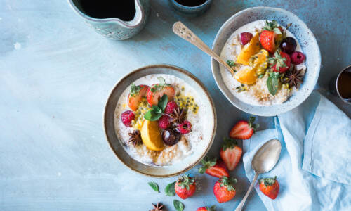 Two bowls of yoghurt and fruit