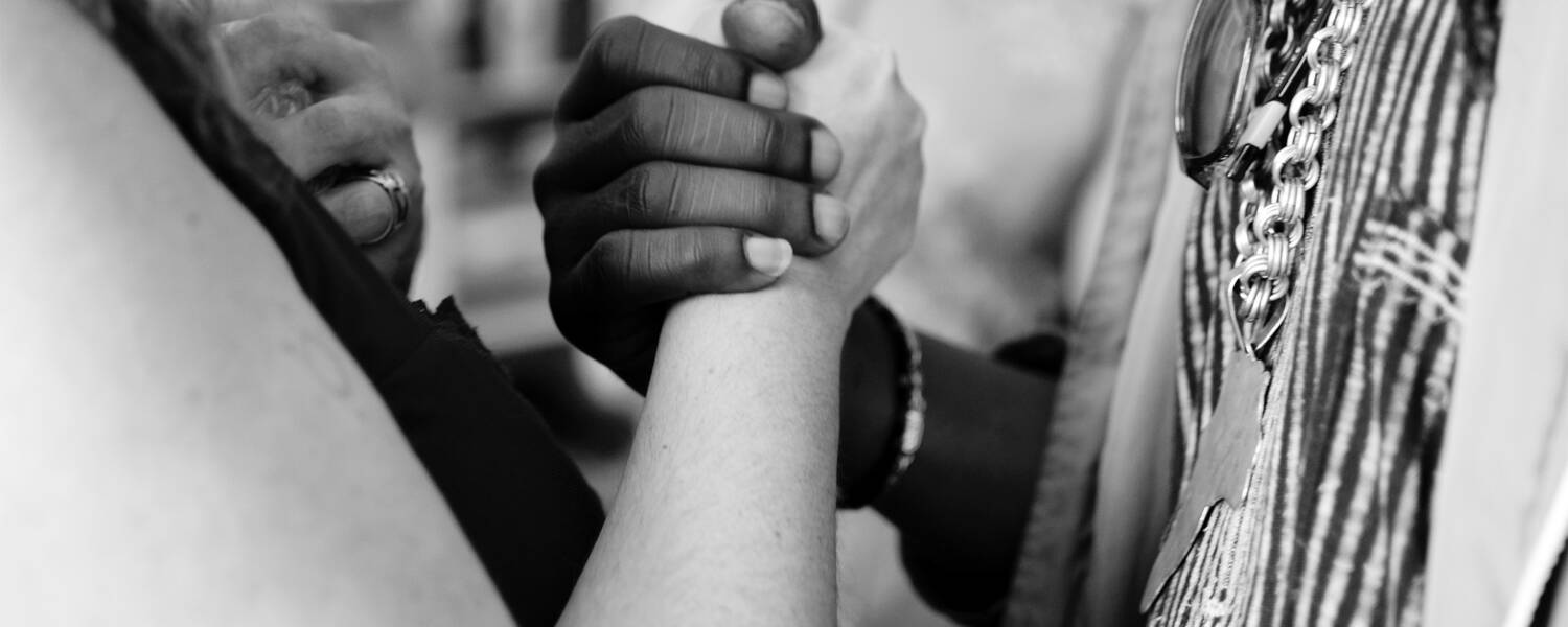 Two students locking hands in unity