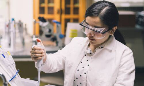 Salem College Student in lab processing samples