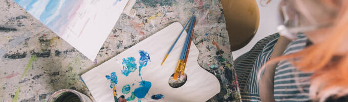 Salem College student taking paint from a palette