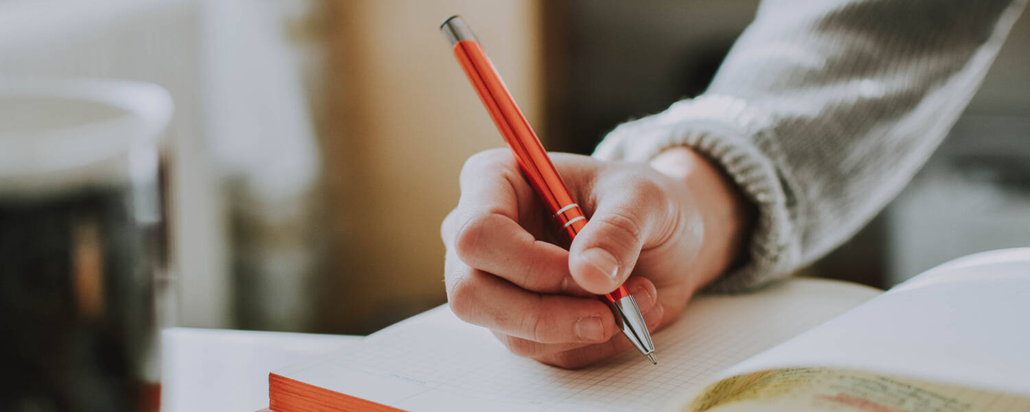 Person writing in a notebook