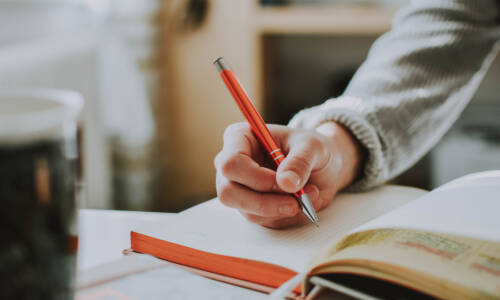 Person writing in a notebook