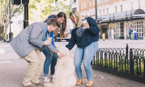 Salem College students petting a dog