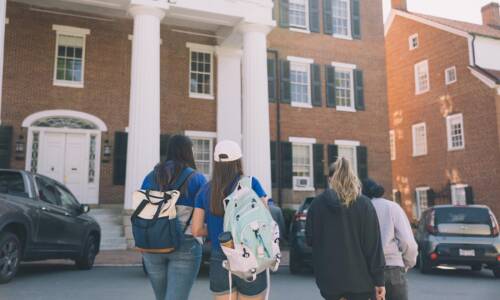 Students walking in front of a campus building at Salem College