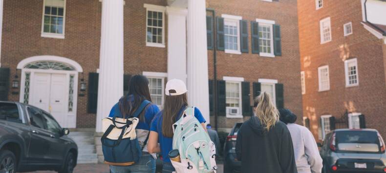 Students walking in front of a campus building at Salem College