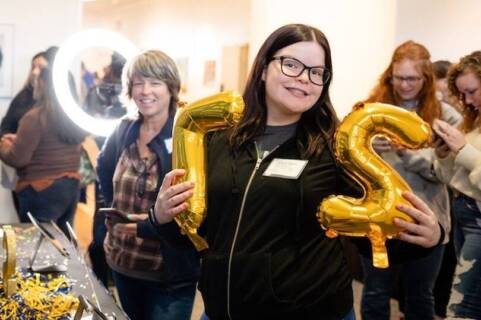 Ticket to Salem event student holding balloons