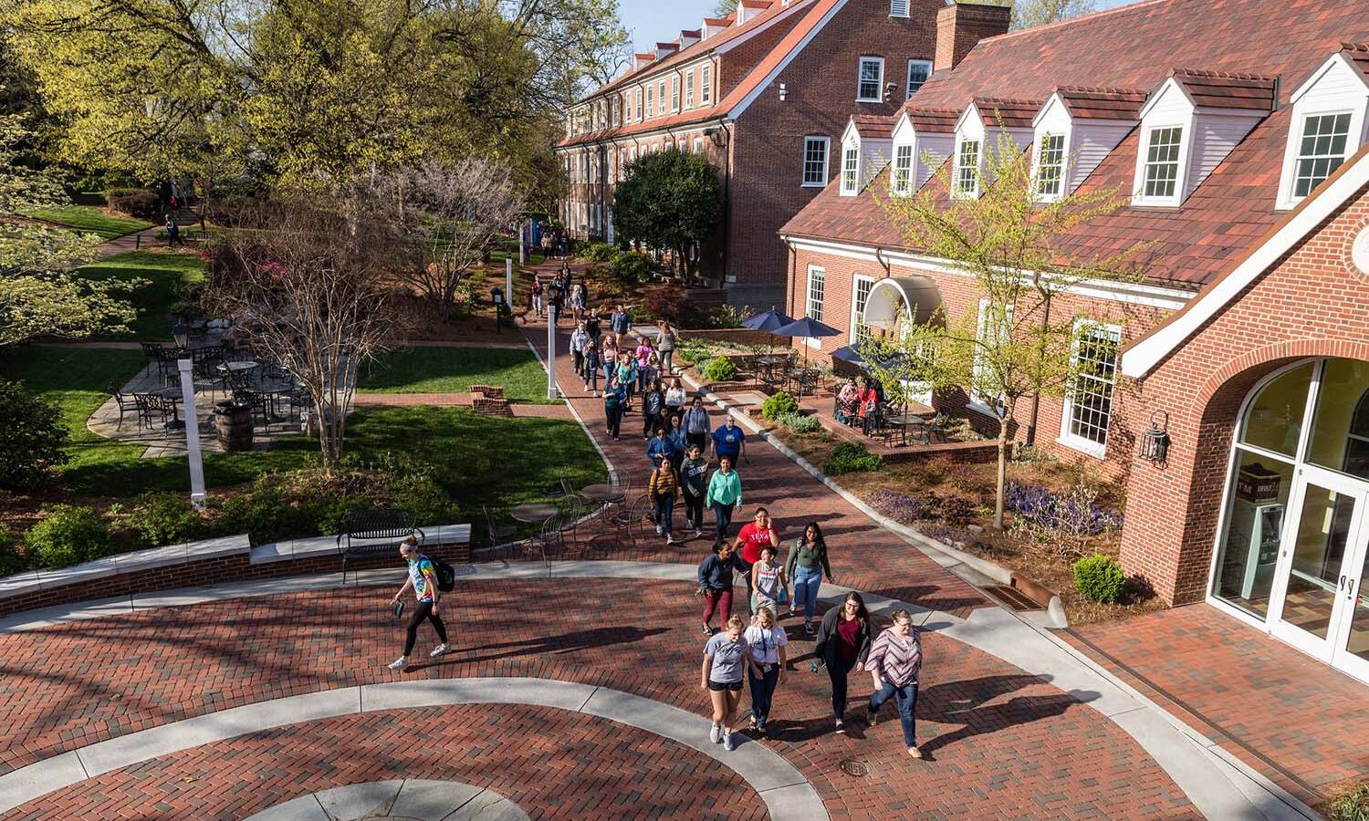Salem College students walking on campus in front of student life building