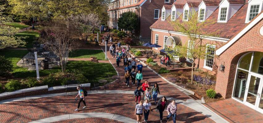 Salem College students walking on campus in front of student life building