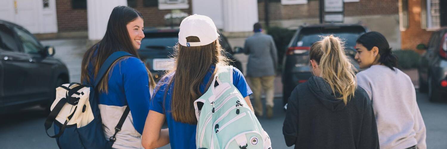 Students walking on Salem College Campus with their backpacks