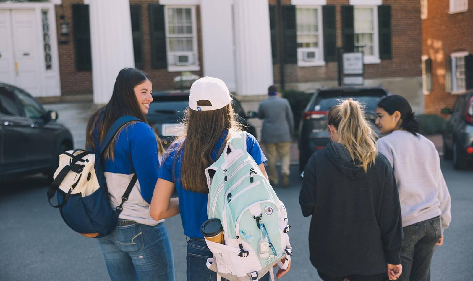 Students walking on Salem College Campus with their backpacks