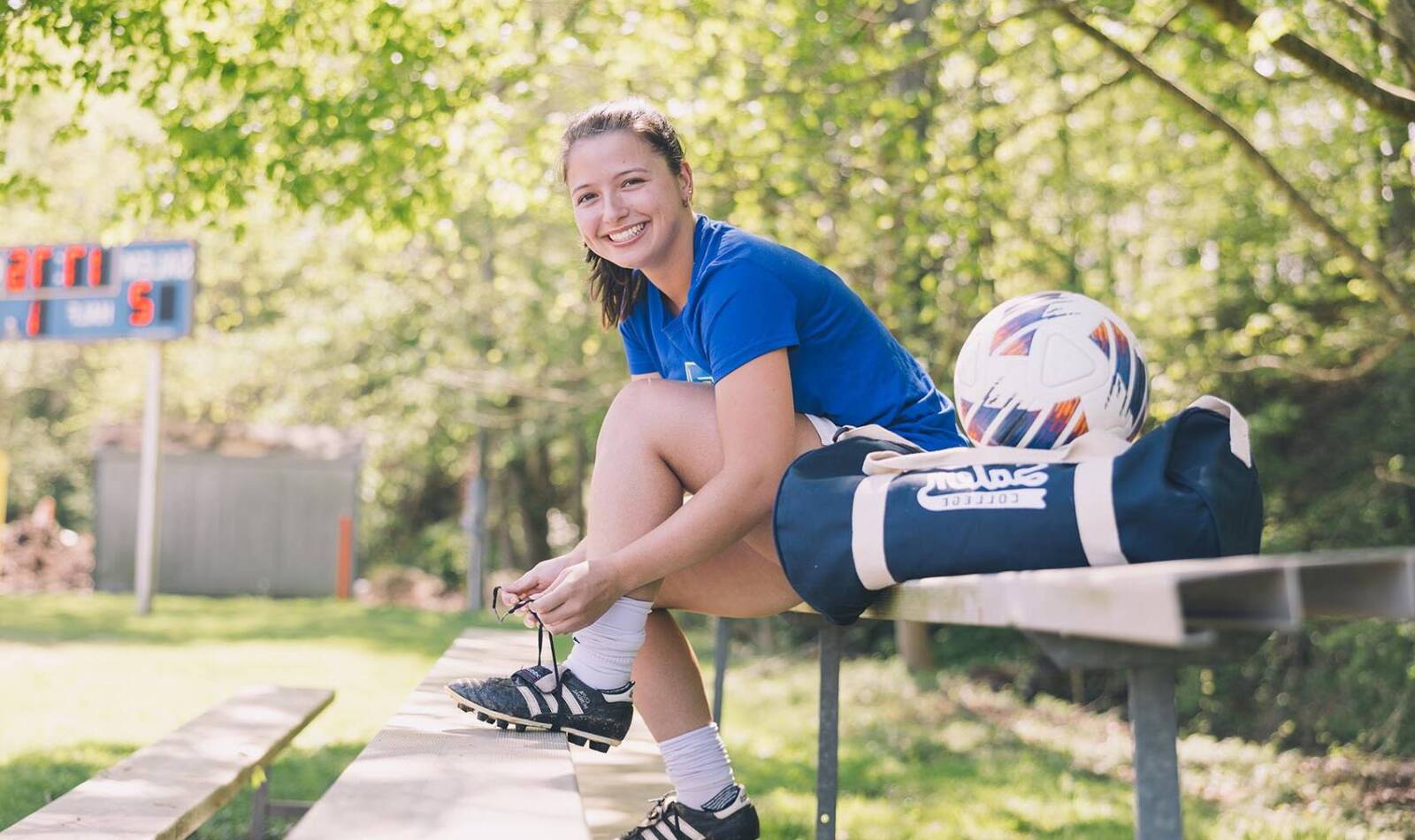 Salem College soccer athlete tying her shoe