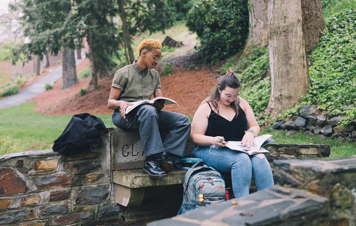 Two students reading outside