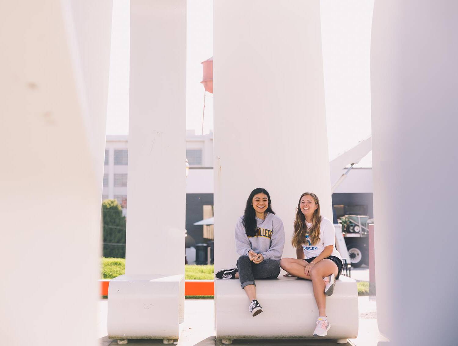 Students outside sitting on bench
