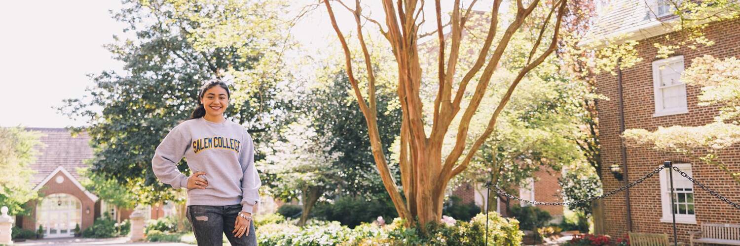 Student poses outside of Salem College building