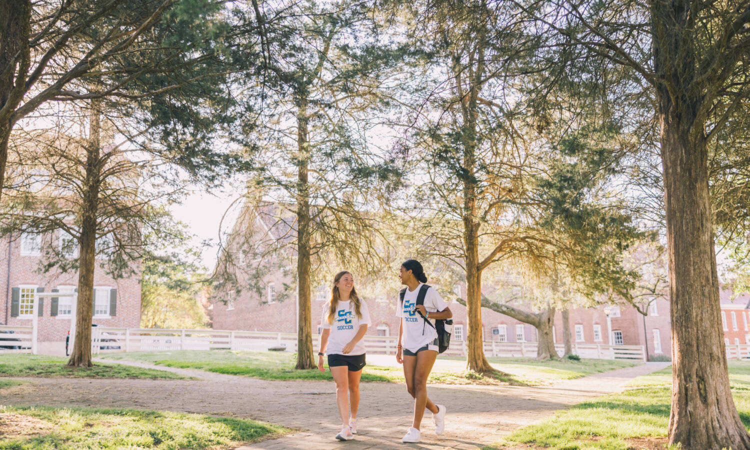 Salem College Soccer players walking down campus path