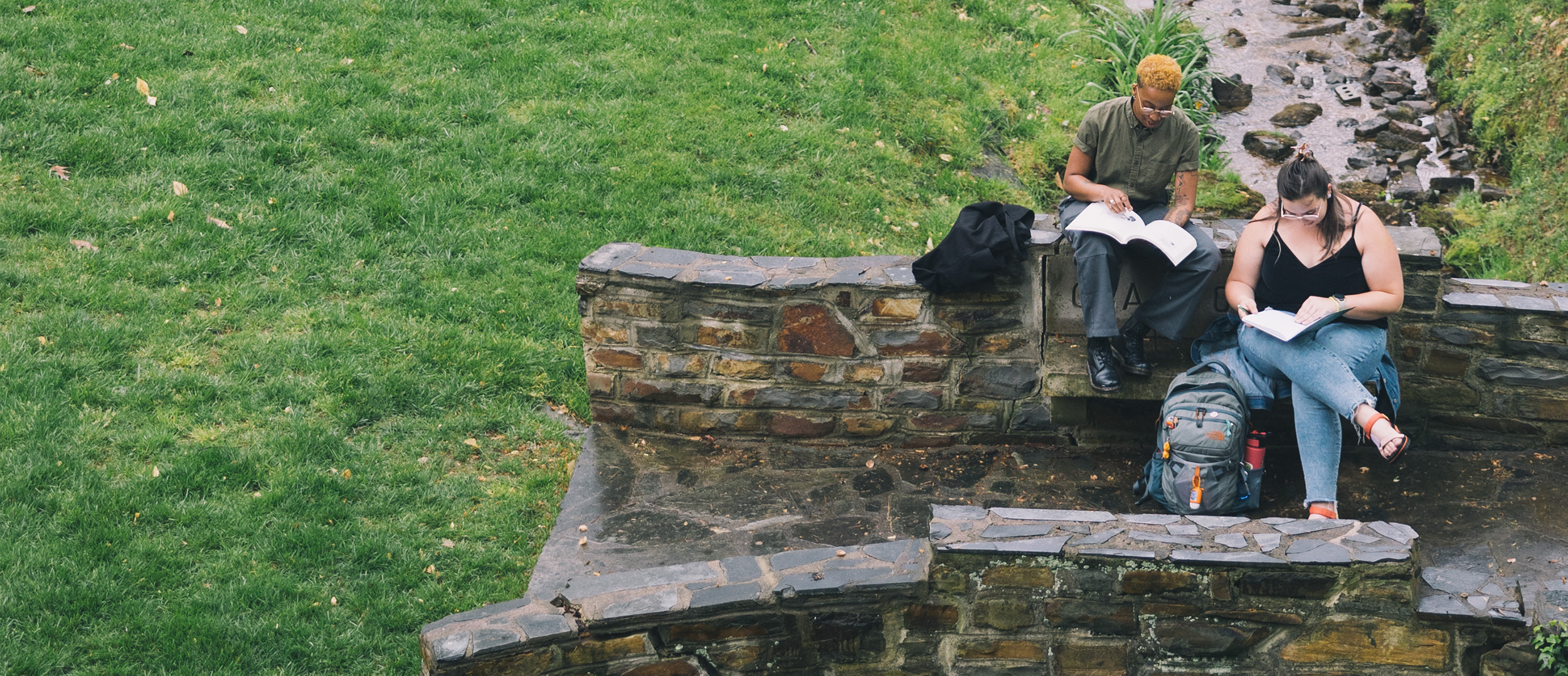 Two students sitting in the May Dell