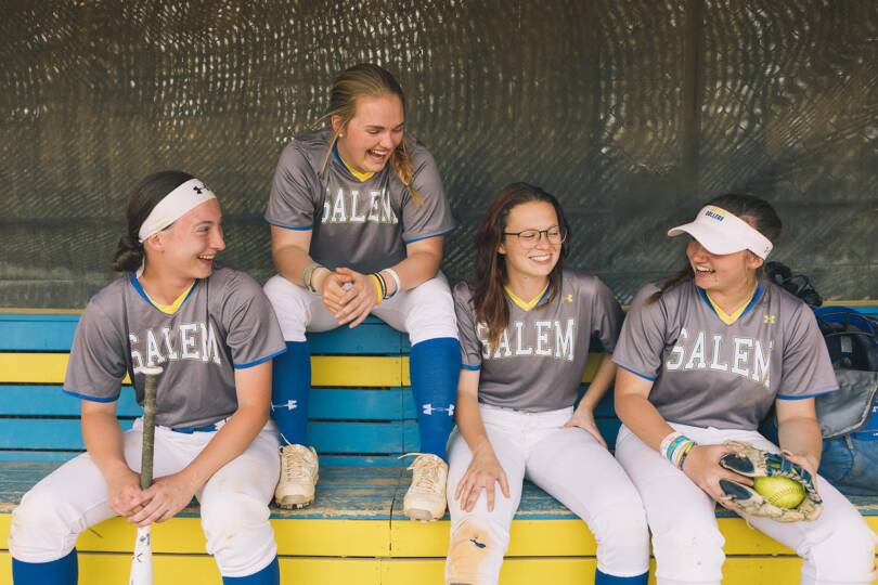 Salem College student athletes sit at softball game